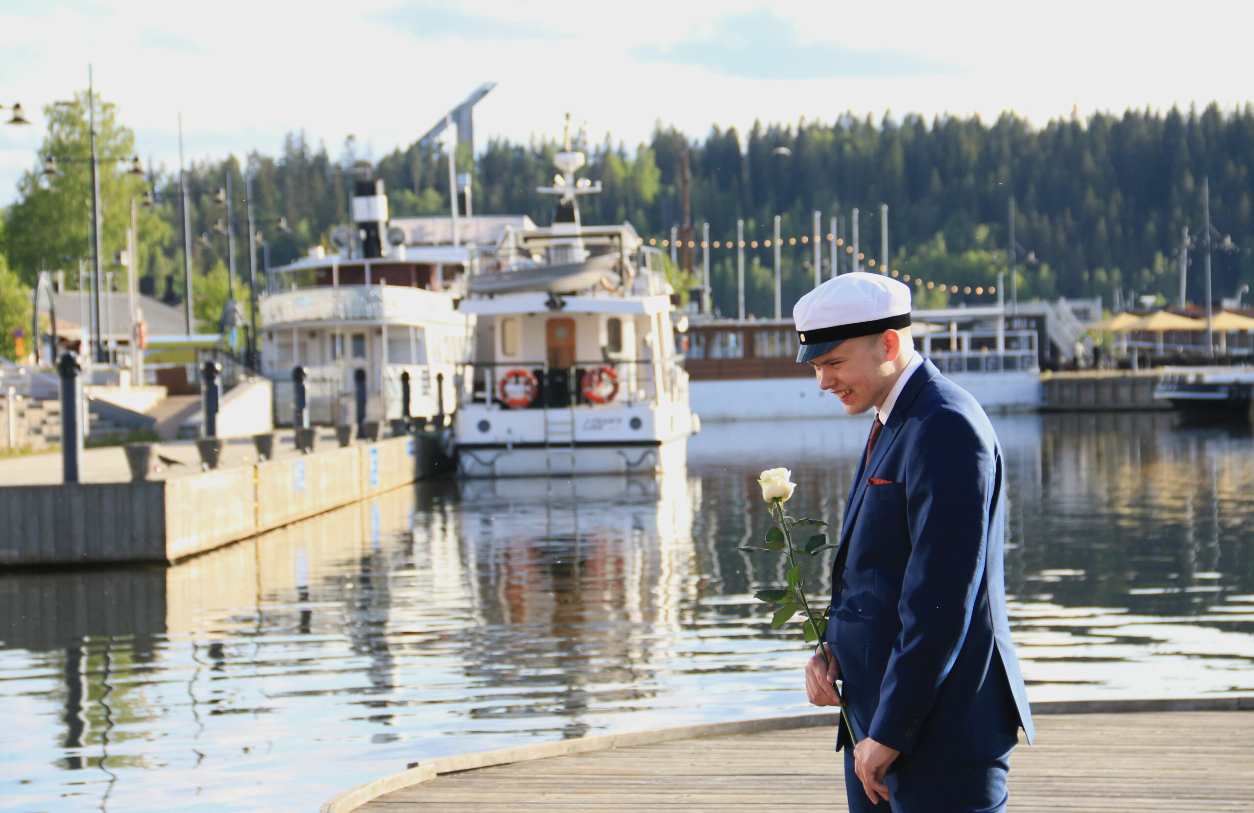 Ylioppilas sataman laiturilla laivojen edessä